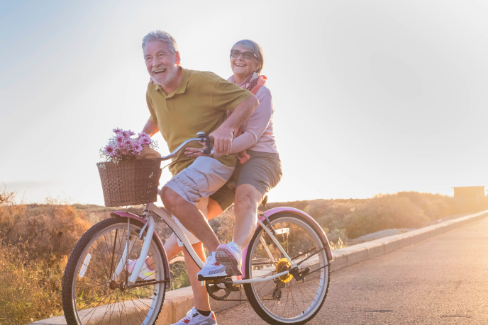 Couple riding tandem bike