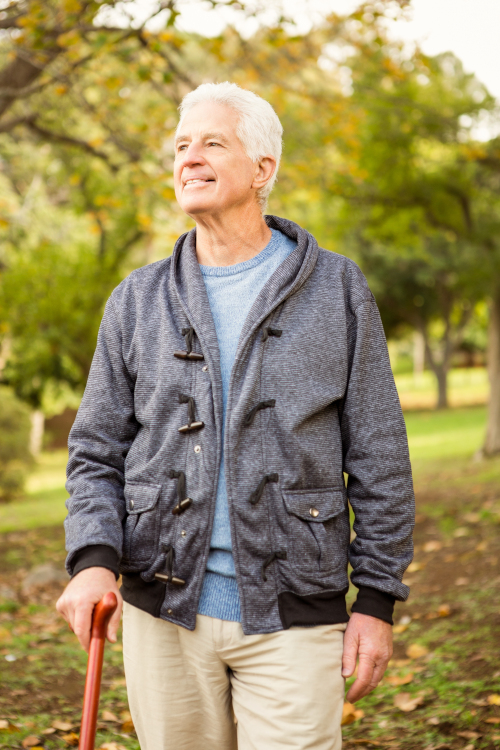 Man walking in the park with a cane