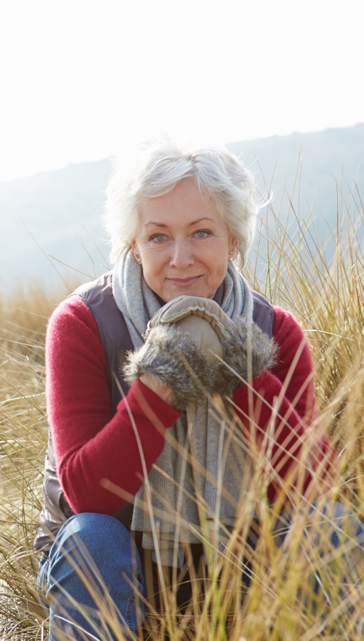Woman sitting in front of lake