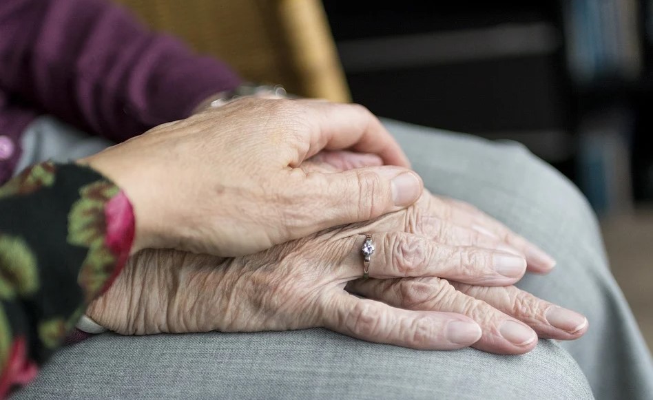 Senior citizens holding hands