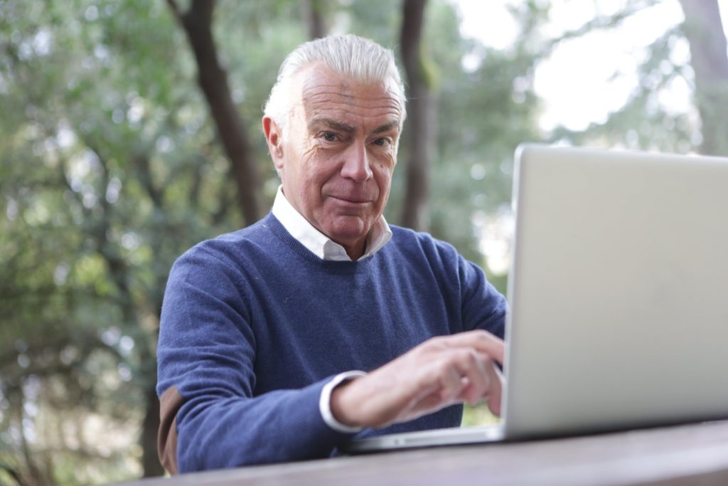 Senior man looking at a laptop