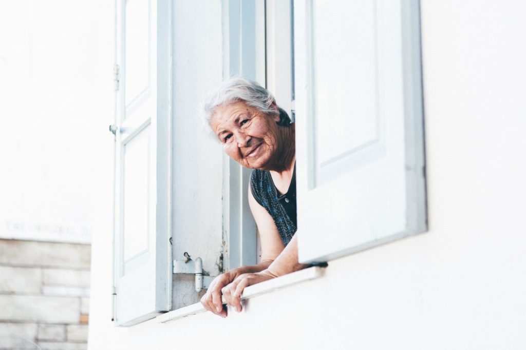 Senior woman looking out a window