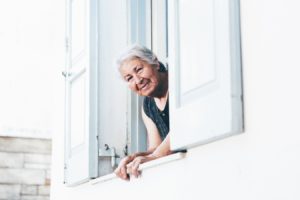 Senior woman looking out a window