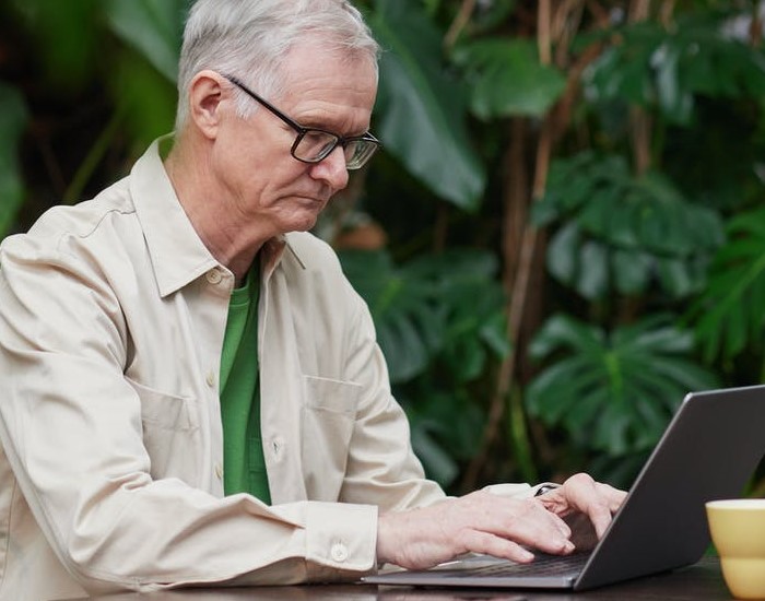 Elderly man looking at a computer