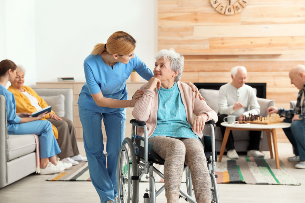 caretaker attending to a woman at a nursing home