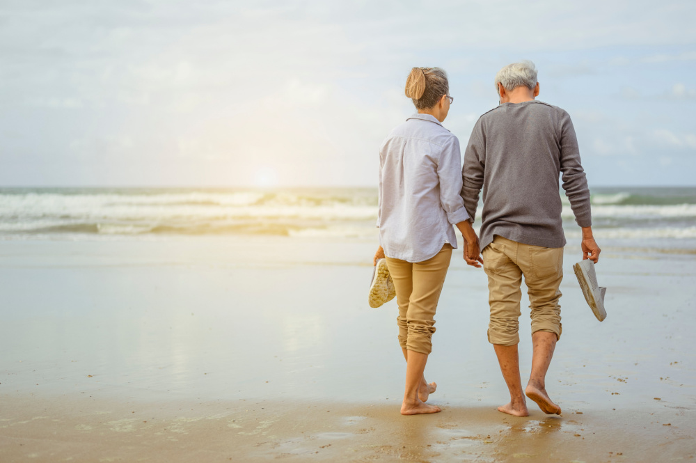 Senior couple walking on a beach