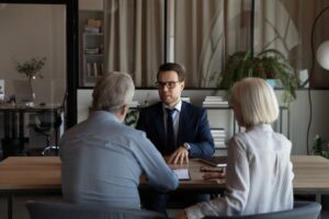 Senior couple meeting with an advisor to determine if they should sell their life insurance policy