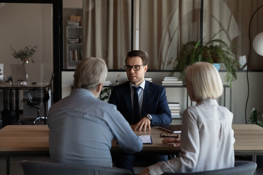 Senior couple meeting with an advisor to determine if they should sell their life insurance policy